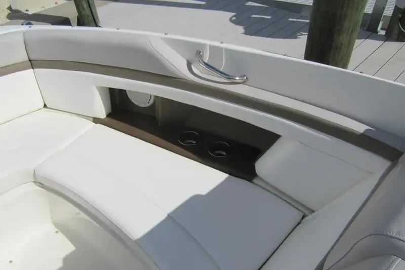 Slide: The Image of Interior seating of a 2011 Sea Ray SLX 250 boat with cup holders. - 15
