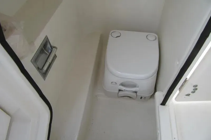 Slide: The Image of Compact marine toilet in 2011 Sea Ray SLX 250 boat interior. - 31