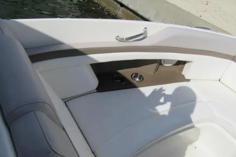 Slide: The Image of Interior seating of a 2011 Sea Ray SLX 250 boat with cup holders. - 14