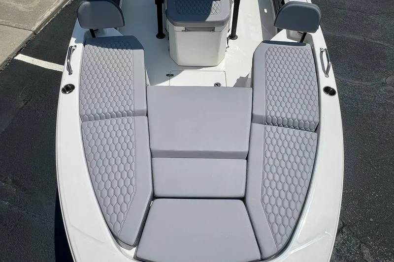 Slide: The Image of 2027 Pathfinder 2200 TRS boat with gray cushioned seating and hexagonal pattern design. - 27