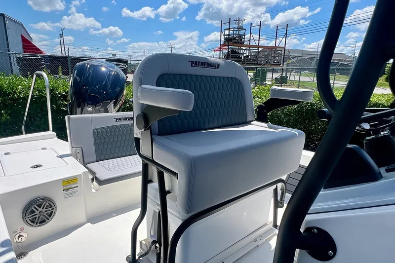 Slide: The Image of 2027 Pathfinder 2200 TRS boat interior with seating and motor, under a clear blue sky. - 18