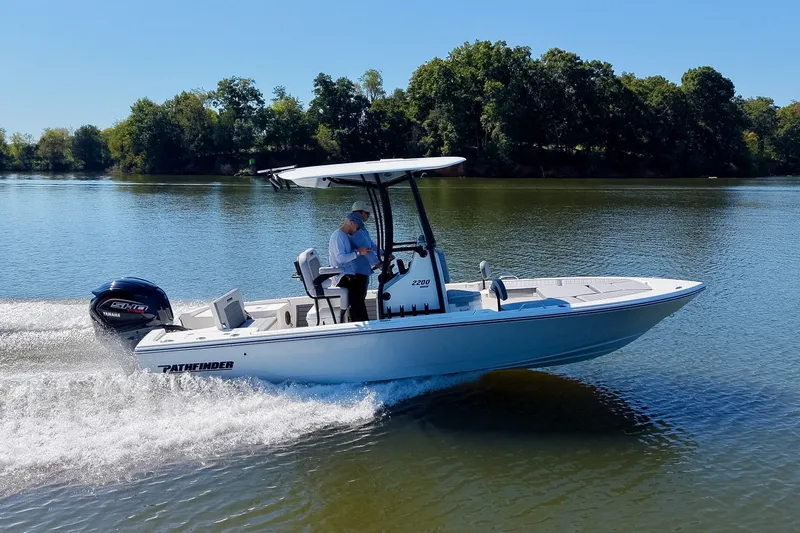 Slide: The Image of Pathfinder 2200 Hybrid boat cruising on a serene lake, 2027 model. - 25