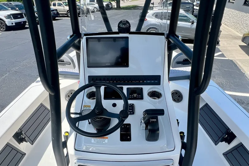 Slide: The Image of 2027 Pathfinder 2200 TRS boat console with steering wheel and navigation display. - 20