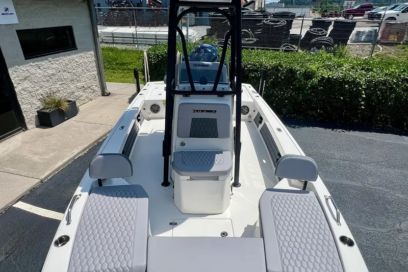 Slide: The Image of 2027 Pathfinder 2200 TRS boat with sleek seating and modern design in a sunny outdoor setting. - 26