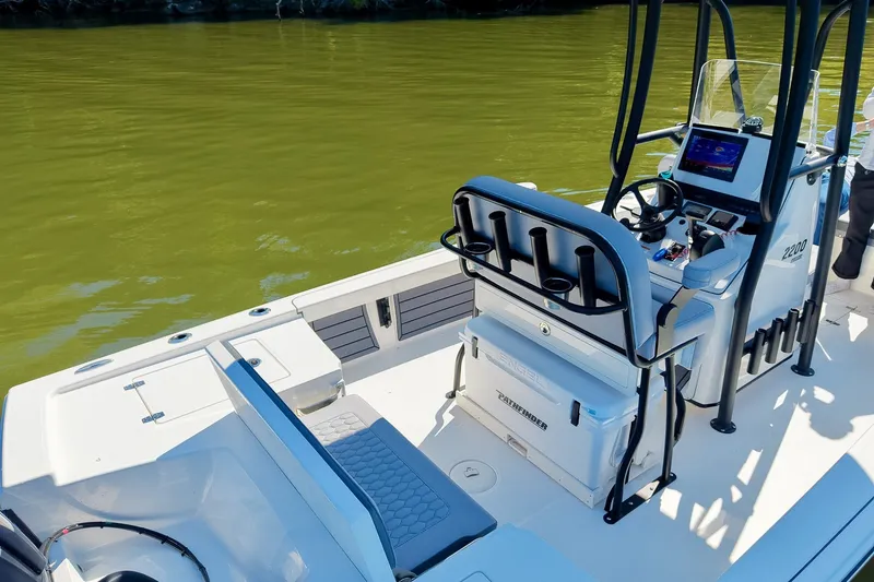 Slide: The Image of 2027 Pathfinder 2200 Hybrid boat interior with modern console and seating on calm water. - 53