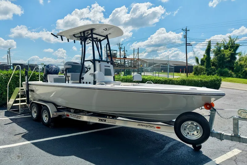 The Image of 2027 Pathfinder 2200 TRS boat on trailer under clear blue sky. - 0