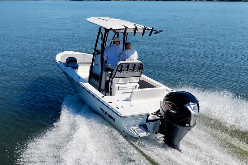 Slide: The Image of 2027 Pathfinder 2200 Hybrid boat cruising on open water with two passengers. - 31