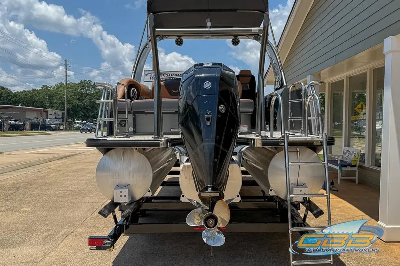 Slide: The Image of 2022 South Bay 523 SB2 ARCH pontoon boat with powerful outboard motor, parked outdoors. - 8