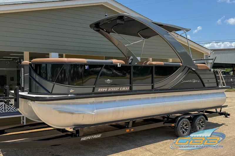 The Image of 2022 South Bay 523 SB2 ARCH pontoon boat on trailer, displayed outdoors. - 0