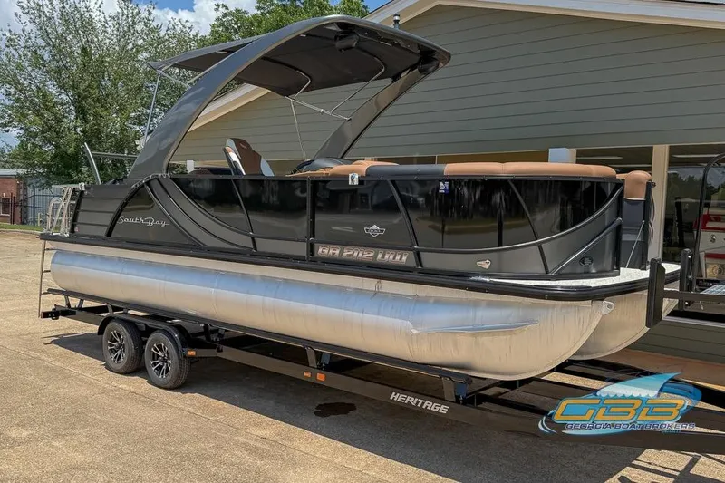 Slide: The Image of 2022 South Bay 523 SB2 ARCH pontoon boat on trailer, parked outdoors. - 9