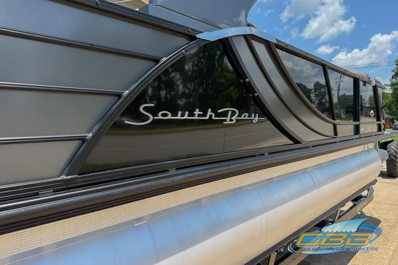Slide: The Image of 2022 South Bay 523 SB2 ARCH pontoon boat with sleek black exterior design. - 13