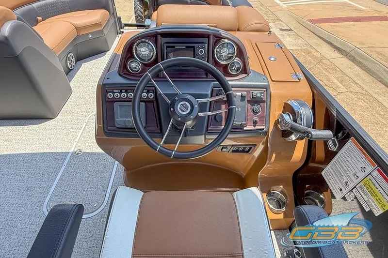 Slide: The Image of 2022 South Bay 523 SB2 ARCH boat dashboard with steering wheel and control panel. - 5