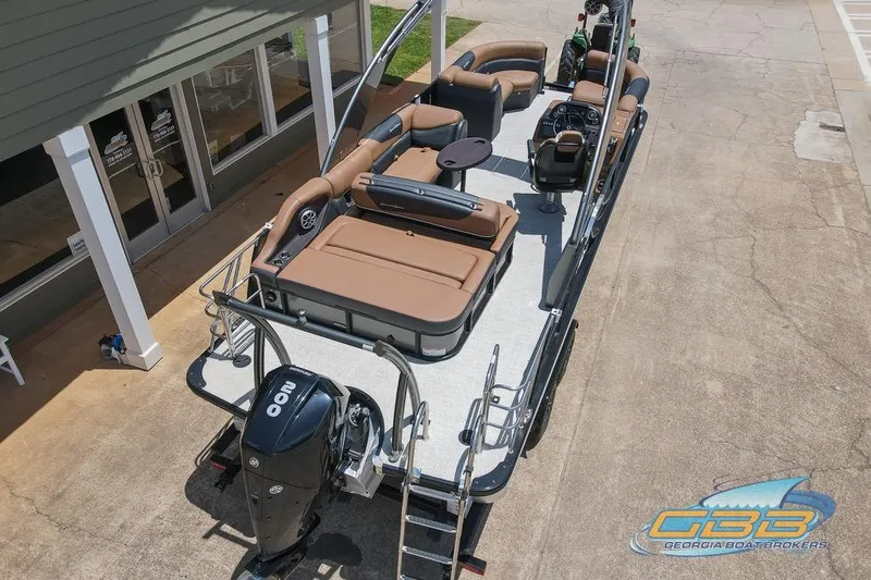 Slide: The Image of 2022 South Bay 523 SB2 ARCH pontoon boat with brown seating and outboard motor. - 26