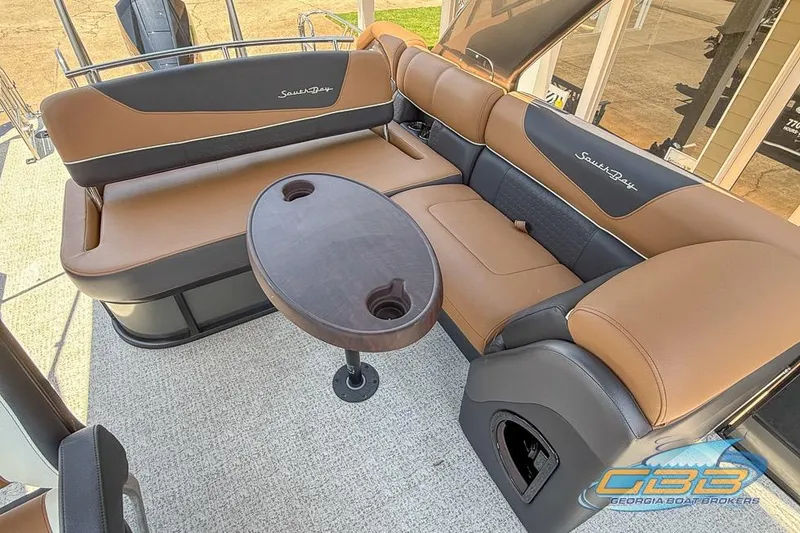 Slide: The Image of Luxurious 2022 South Bay 523 SB2 ARCH boat interior with brown seating and oval table. - 18