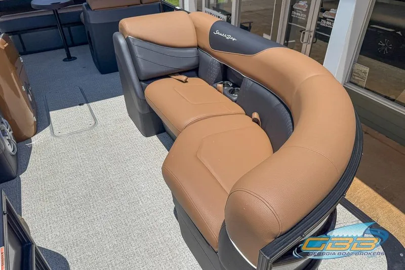 Slide: The Image of Luxurious seating on 2022 South Bay 523 SB2 ARCH pontoon boat, featuring tan and black upholstery. - 20