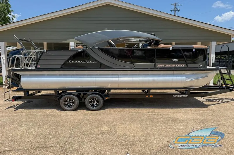Slide: The Image of 2022 South Bay 523 SB2 ARCH pontoon boat on trailer, parked outdoors. - 27