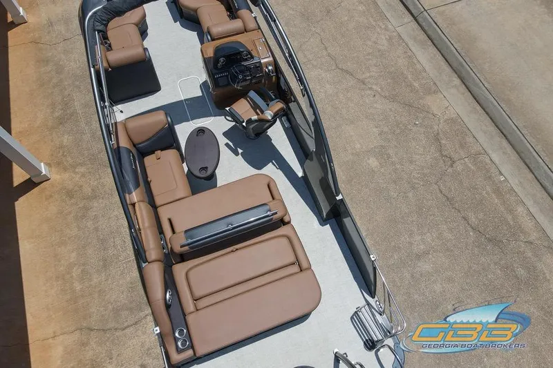 Slide: The Image of 2022 South Bay 523 SB2 ARCH pontoon boat with brown seating and modern dashboard. - 4