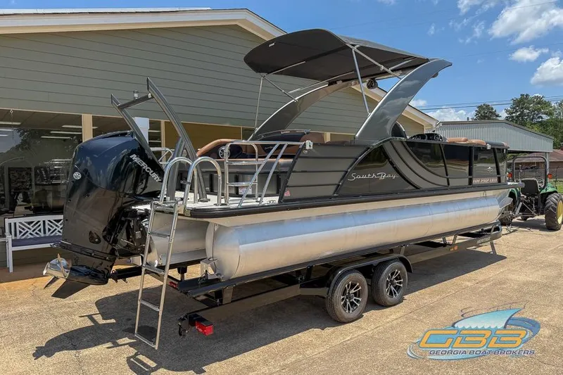 Slide: The Image of 2022 South Bay 523 SB2 ARCH pontoon boat on trailer, displayed outdoors. - 11