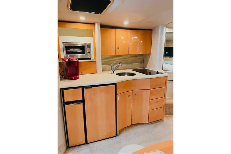 Slide: The Image of 2003 Formula 40 Performance Cruiser kitchen with modern appliances and wooden cabinetry. - 10
