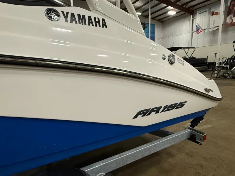 Slide: The Image of A 2024 Yamaha AR195 boat is on a trailer inside a warehouse. - 1