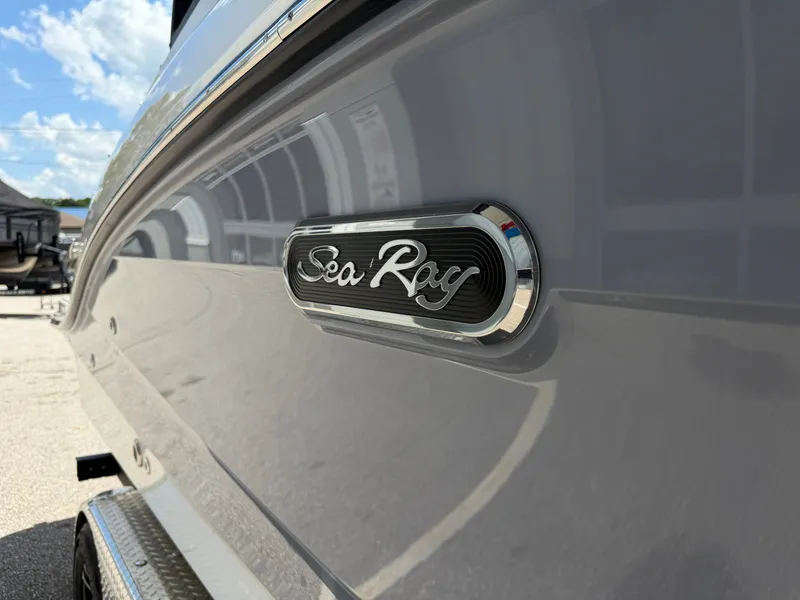 Slide: The Image of Close-up of the Sea Ray SPX 210 with a shiny hull and brand logo. - 10