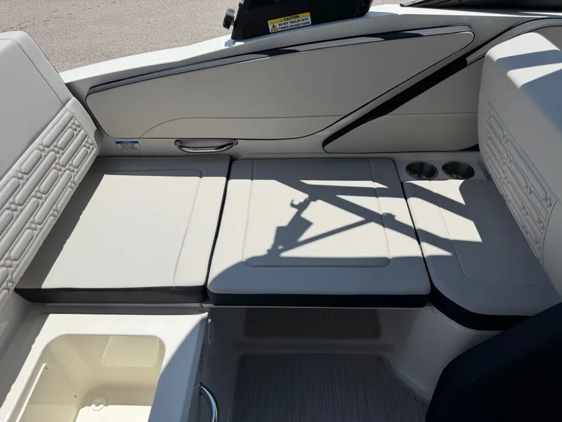 Slide: The Image of The image shows the cockpit of a Sea Ray SPX 210 boat with beige upholstery and cup holders. - 26