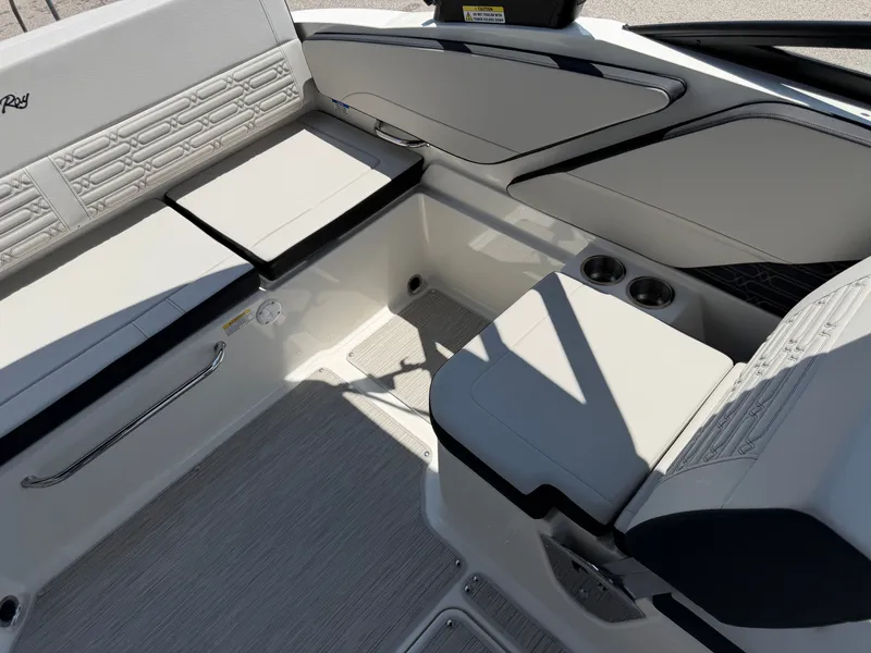 Slide: The Image of The image shows the interior of a Sea Ray SPX 210 boat with sleek white seating. - 28