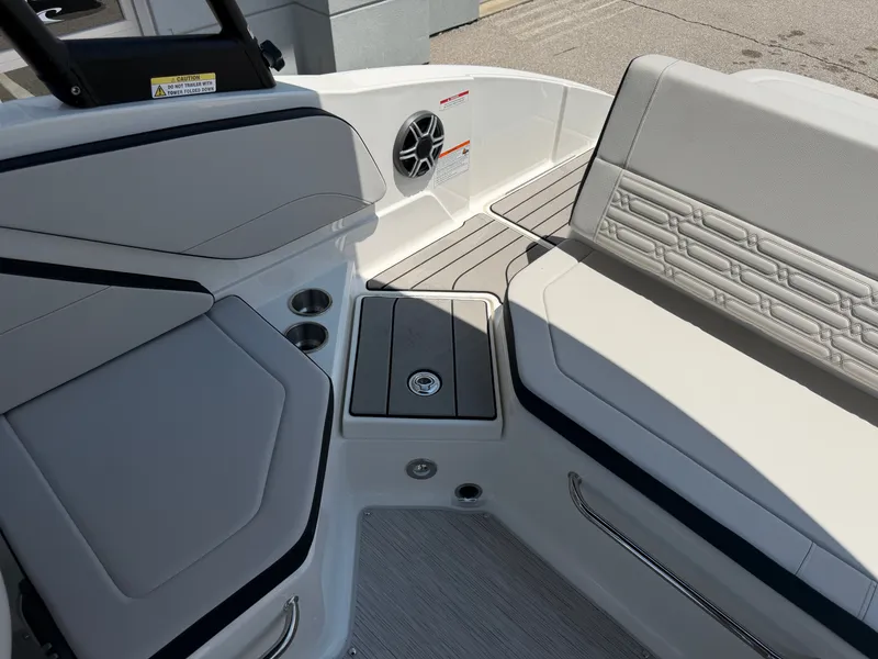 Slide: The Image of The image shows the cockpit of a 2027 Sea Ray SPX 210 boat with sleek seating and speakers. - 21