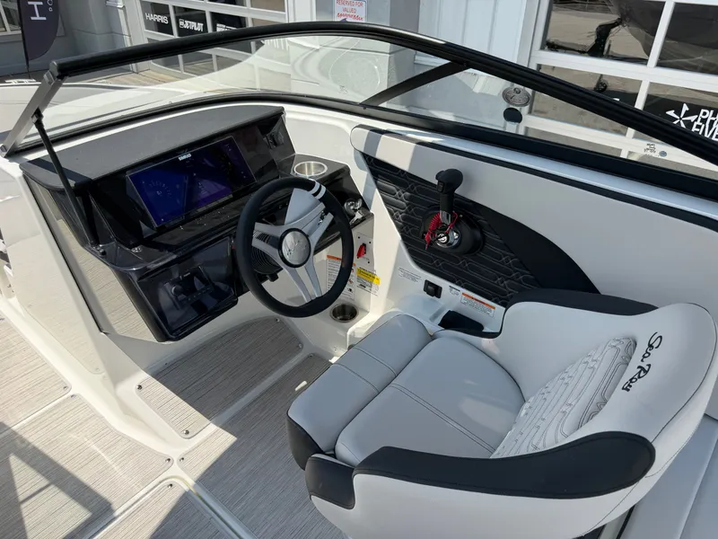 Slide: The Image of The cockpit of the 2027 Sea Ray SPX 210 features a modern steering wheel and digital display. - 49