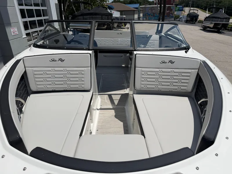 Slide: The Image of The image shows the cockpit of a Sea Ray SPX 210 boat with gray upholstery and a modern design. - 9