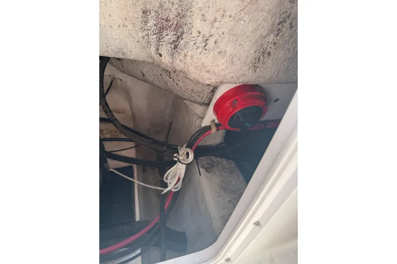 Slide: The Image of Electrical wiring and red switch inside a 2006 Pro-Line 24 Walkaround boat. - 14