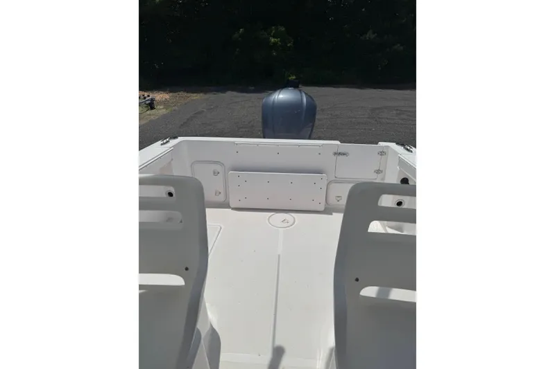 Slide: The Image of 2006 Pro-Line 24 Walkaround boat interior with seating and engine view. - 20