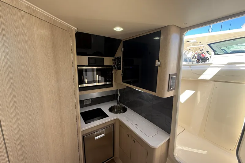 Slide: The Image of Modern kitchen interior of 2026 Scout 400 LXF boat with sleek appliances and cabinetry. - 17