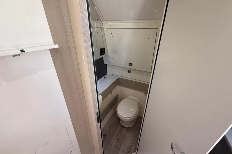 Slide: The Image of 2026 Scout 400 LXF boat bathroom interior with modern fixtures and compact design. - 18