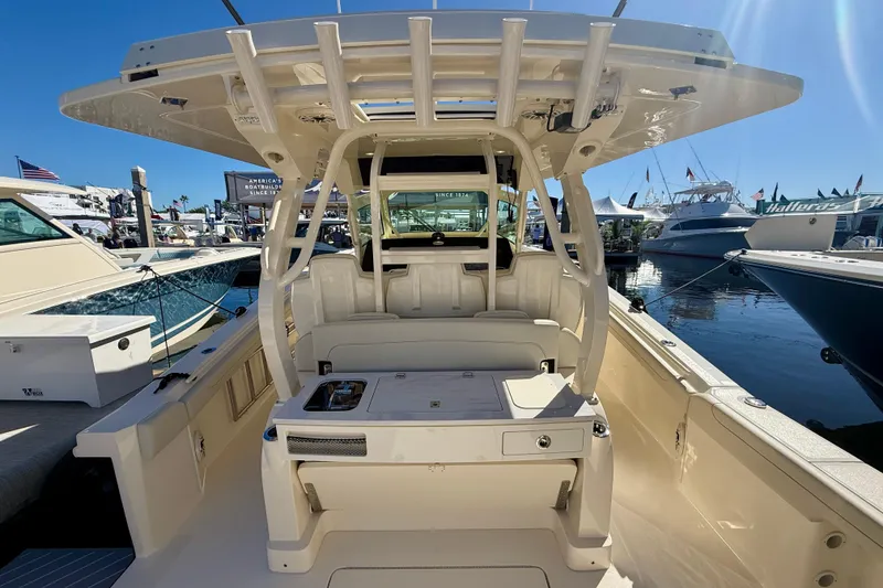 Slide: The Image of 2026 Scout 400 LXF luxury boat interior at marina, showcasing seating and helm station. - 7
