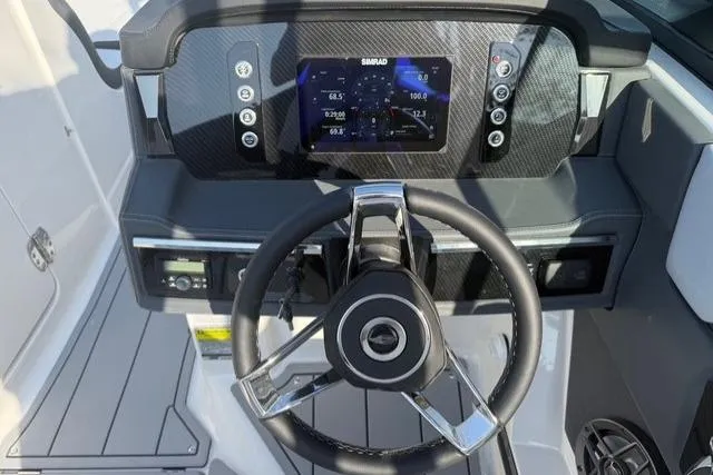 Slide: The Image of 2026 Chaparral SSX 4 boat dashboard with steering wheel and digital display. - 18
