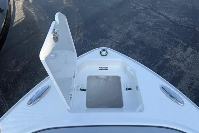 Slide: The Image of 2026 Chaparral SSX 4 boat bow storage compartment open on a sunny day. - 9