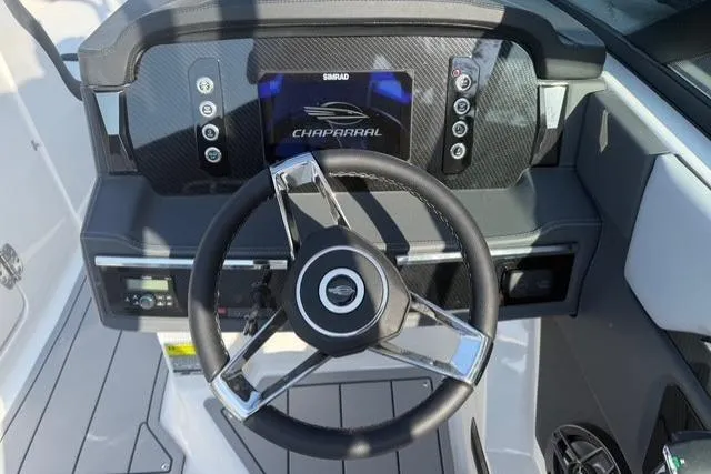 Slide: The Image of Steering wheel and dashboard of 2026 Chaparral SSX 4 boat, featuring modern controls. - 17