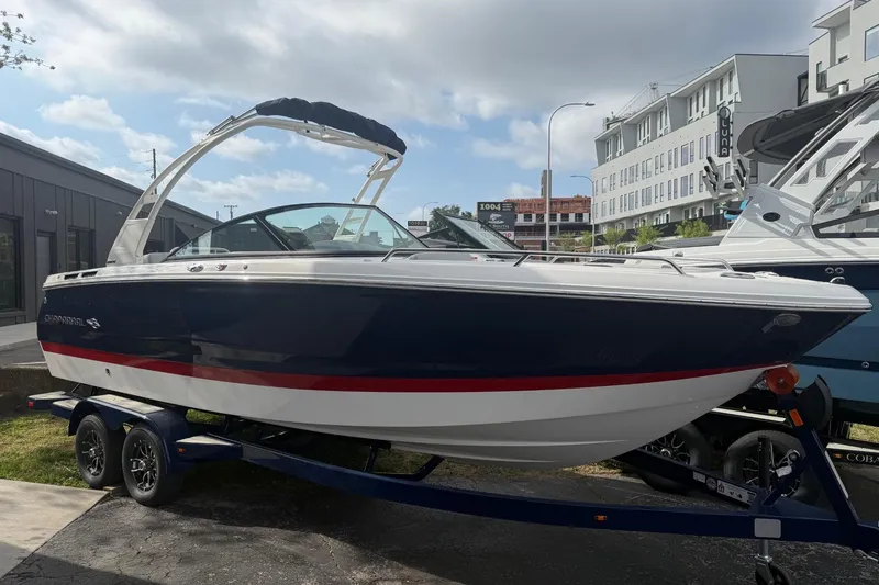 Slide: The Image of 2026 Chaparral SSX 4 boat on trailer, parked outdoors under cloudy sky. - 6