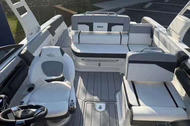 Slide: The Image of 2026 Chaparral SSX 4 boat interior with sleek white seating and modern design. - 8