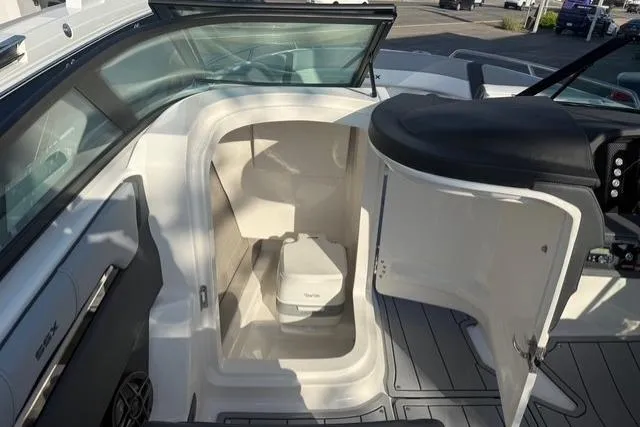 Slide: The Image of 2026 Chaparral SSX 4 boat interior with compact toilet and seating area. - 15