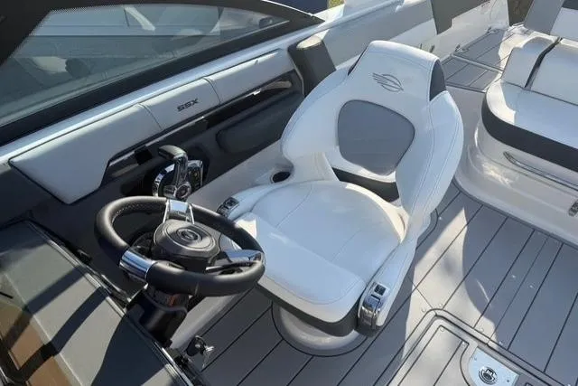 Slide: The Image of 2026 Chaparral SSX 4 boat interior with sleek white seating and modern steering wheel. - 16