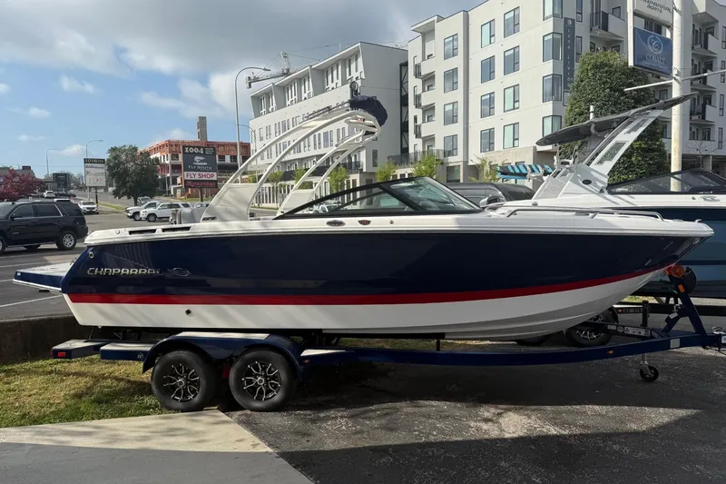 Slide: The Image of 2026 Chaparral SSX 4 boat on trailer, parked in urban setting. - 4