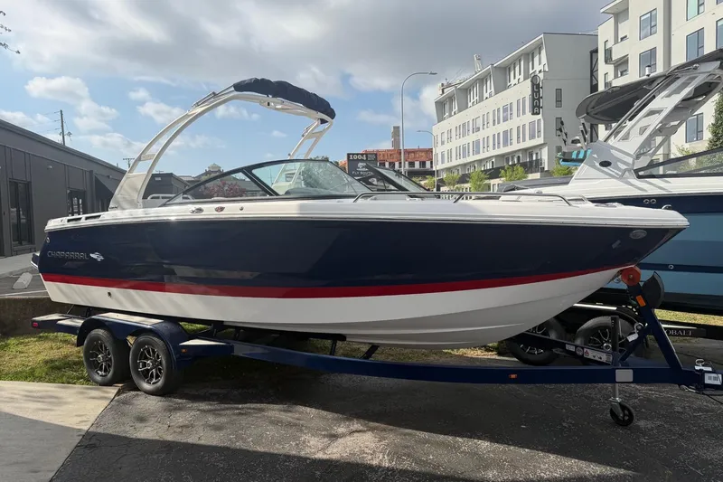 The Image of 2026 Chaparral SSX 4 boat on trailer, blue and white design, parked outdoors. - 2