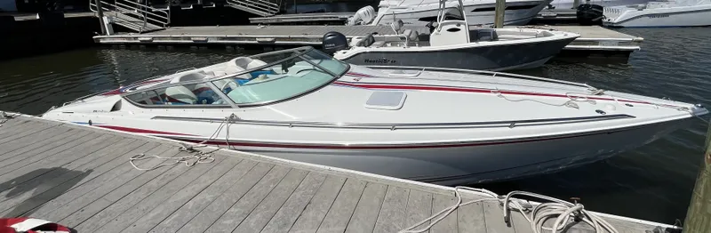Slide: The Image of 2004 Formula 292 FASTech at the dock with sleek design and red accents. - 3