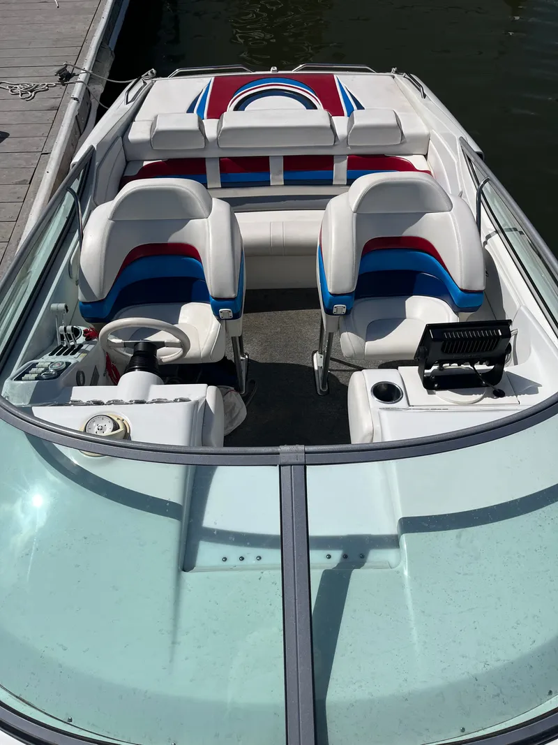 Slide: The Image of The image shows the cockpit of a 2004 Formula 292 FASTech boat with colorful seats. - 9