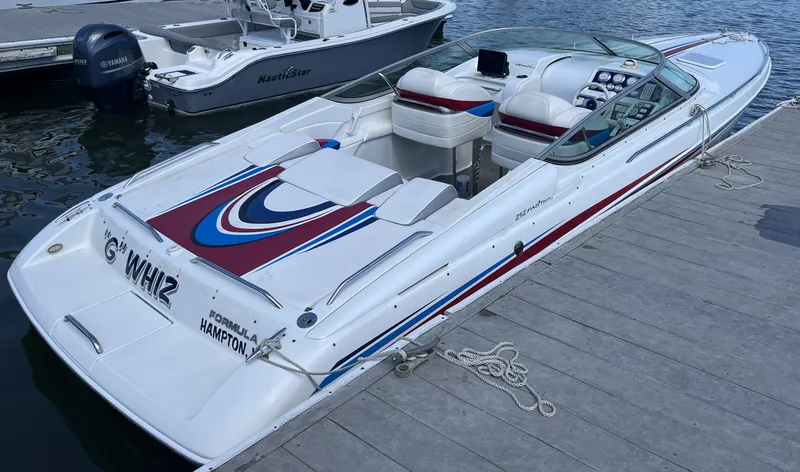 Slide: The Image of A 2004 Formula 292 FASTech boat docked. It features a sporty design with colorful accents. - 2