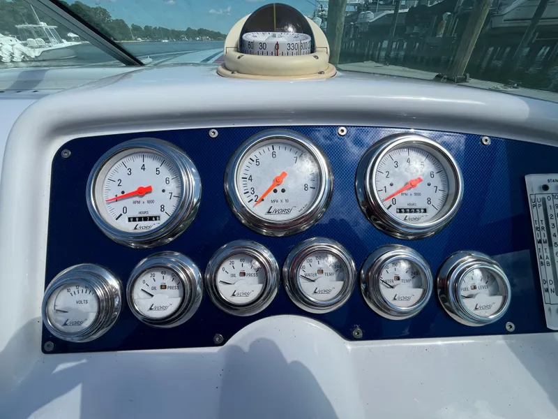 Slide: The Image of Dashboard of a 2004 Formula 292 FASTech with multiple gauges and a compass. - 6