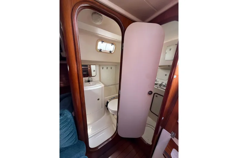 Slide: The Image of Interior view of 1993 Beneteau Oceanis 370 yacht bathroom with wooden accents. - 16