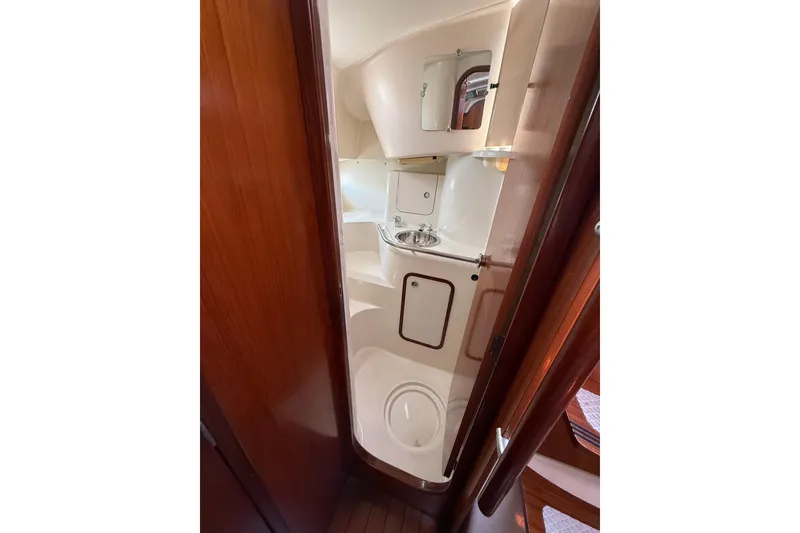 Slide: The Image of Compact bathroom in 1993 Beneteau Oceanis 370 sailboat, featuring sink and mirror. - 14